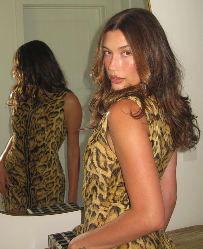 Hailey Bieber posing in a leopard print dress indoors, linked to Father's Day revenge on Justin for Mother's Day post.