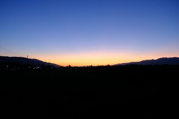 Sunset over distant mountains with a clear sky, illustrating the challenges of being big in Japan for foreigners.