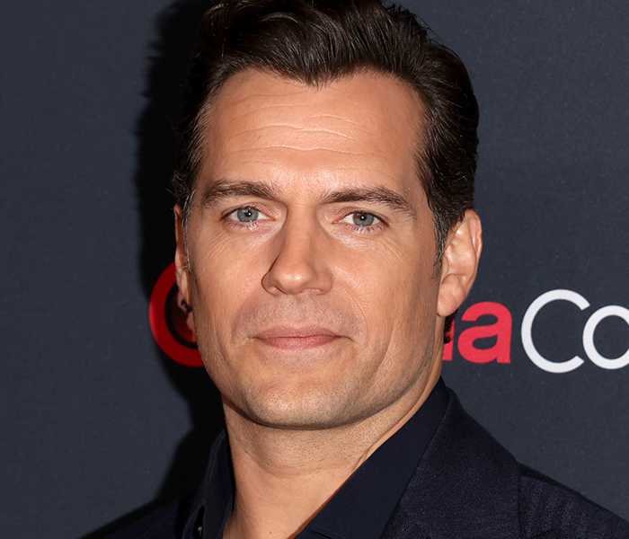 Close-up of a male celebrity with notable facial features highlighting bizarre celebrity body anomalies at a media event.