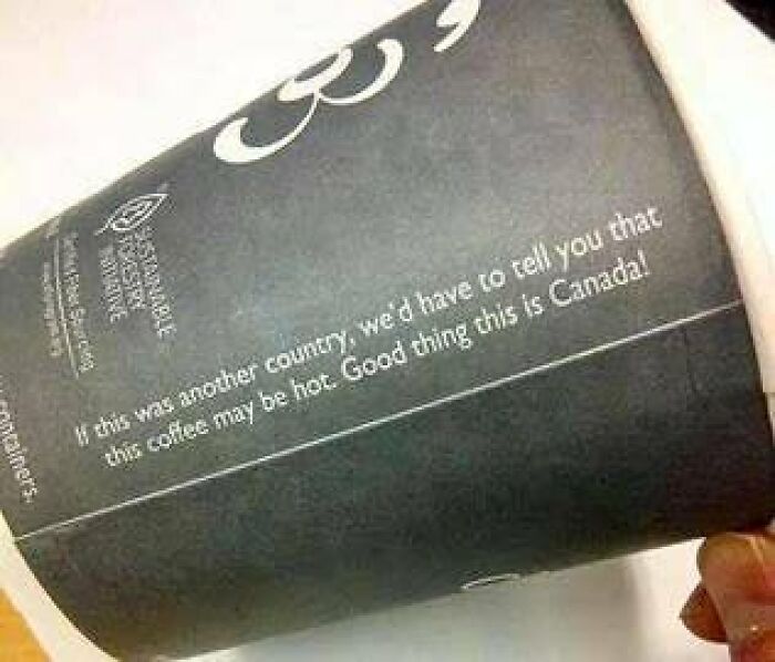 Coffee cup sleeve with humorous text about hot coffee and Canada, adding chaotic and hilarious sign humor to the world.