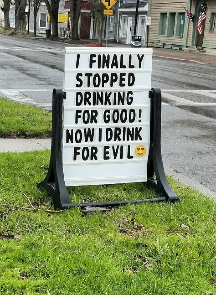 Humorous street sign with funny message about drinking, adding chaos and laughter to the world.