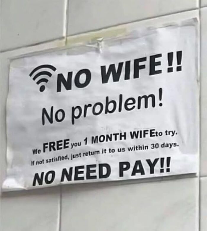Funny sign offering a free one month wife trial with a no pay return policy, adding chaos to the world.