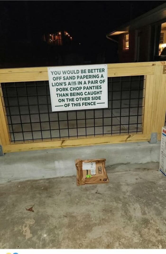 Funny warning sign on a fence humorously deterring trespassers, showcasing hilarious signs that add chaos to the world.