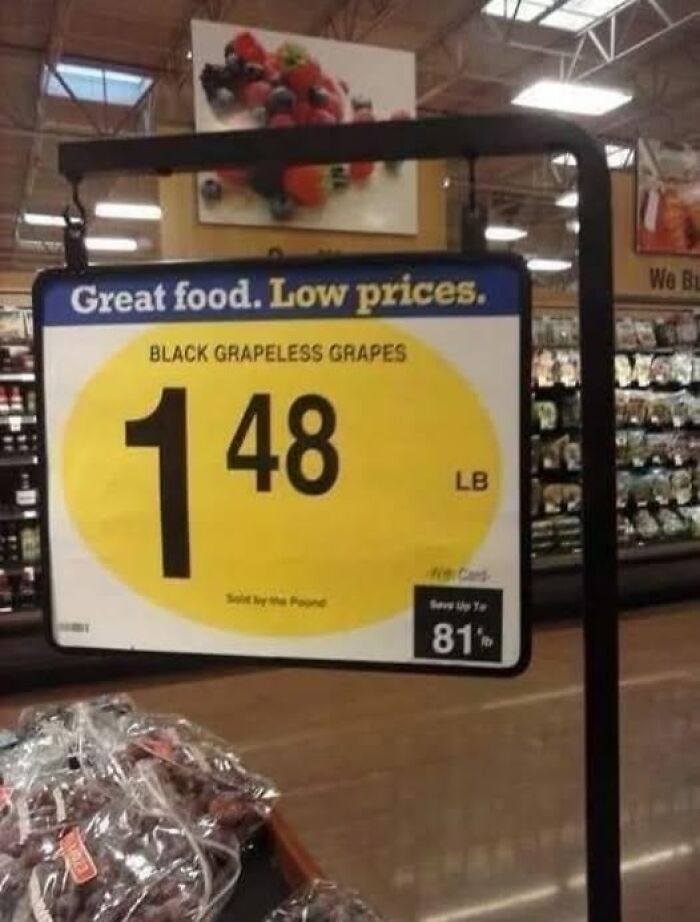 Grocery store sign showing humorous pricing for black grapeless grapes at $1.48 per pound adding chaos to the world.
