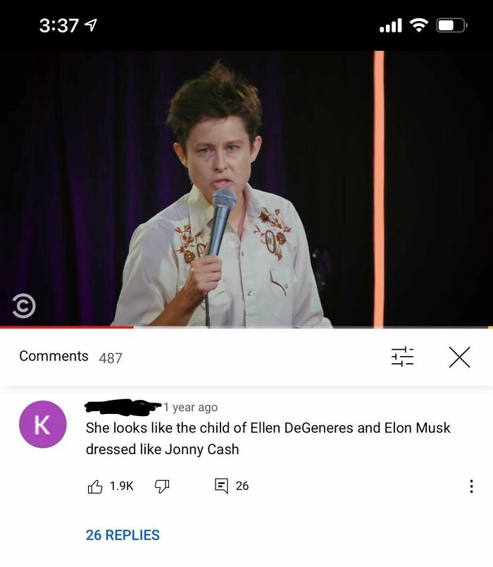 Person on stage with microphone delivering an epic burn comedy roast with funny comment and audience reactions.