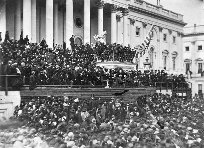 Large crowd gathered outside historic government building, showcasing fascinating historical moments from the past in black and white.