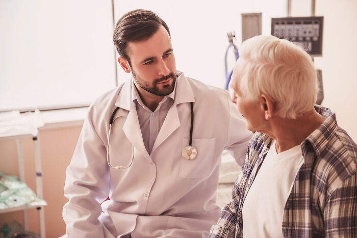 Doctor with stethoscope talking to an elderly man, illustrating folks from history people would love to call.