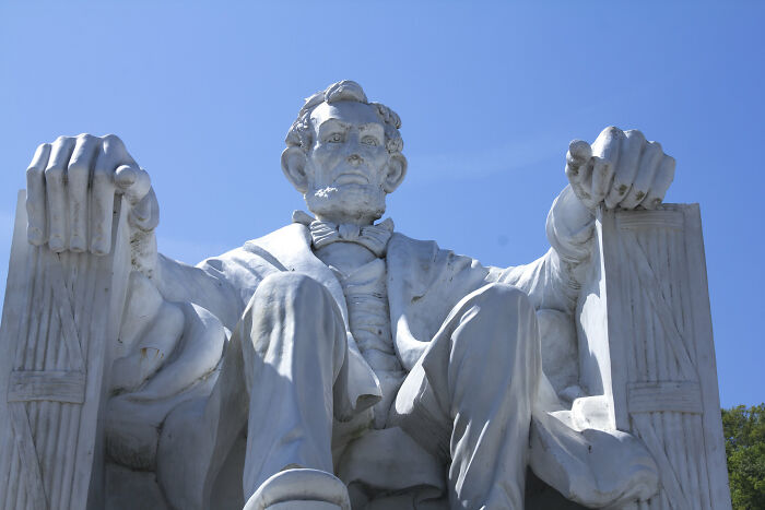 Marble statue of Abe Lincoln seated, highlighting historic figures people would love to call from history.