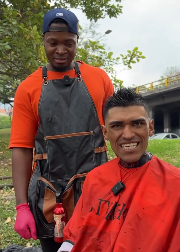 Barber giving a makeover to a homeless man outdoors, with viral reactions over potential model downgrade.