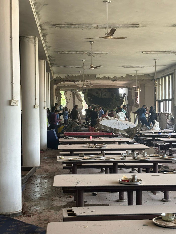 Damaged cafeteria with debris and people investigating aftermath of Air India tragedy, highlighting stars forced to apologize for insensitive posts.
