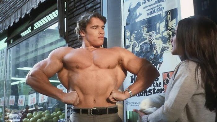 Arnold Schwarzenegger flexing muscles in a movie scene, representing former Hollywood stars who pursued normal careers.