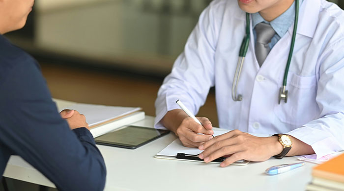 Doctor consulting a man about kidney match results, revealing he is a perfect kidney match for his wife due to close relation. Doctor consulting a man about kidney match results, revealing he is a perfect kidney match for his wife due to close relation.