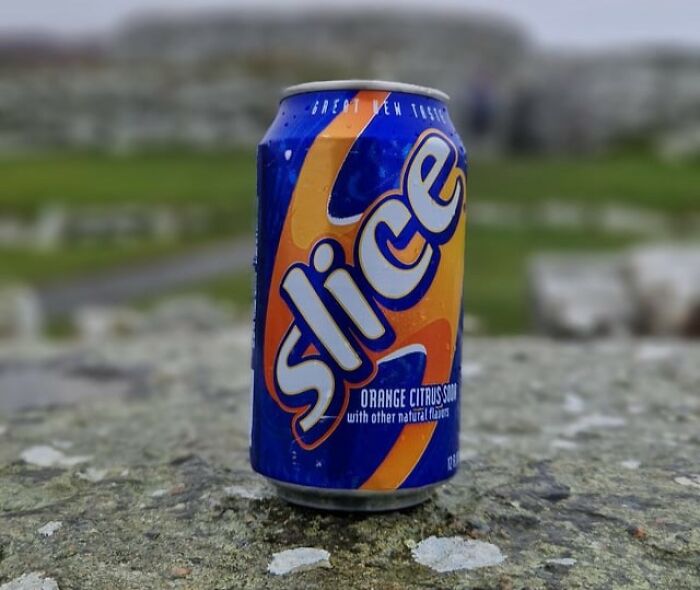 Can of Slice orange citrus soda placed on a stone surface representing beloved foods and drinks that disappeared.