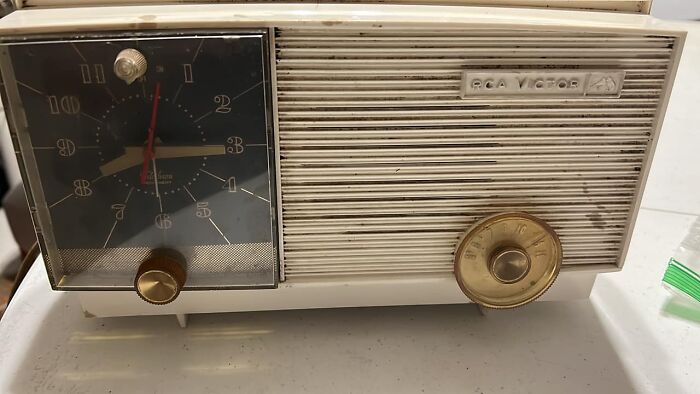Vintage RCA Victor clock radio sitting on a table, an example of unexpected things found in walls and hidden places.