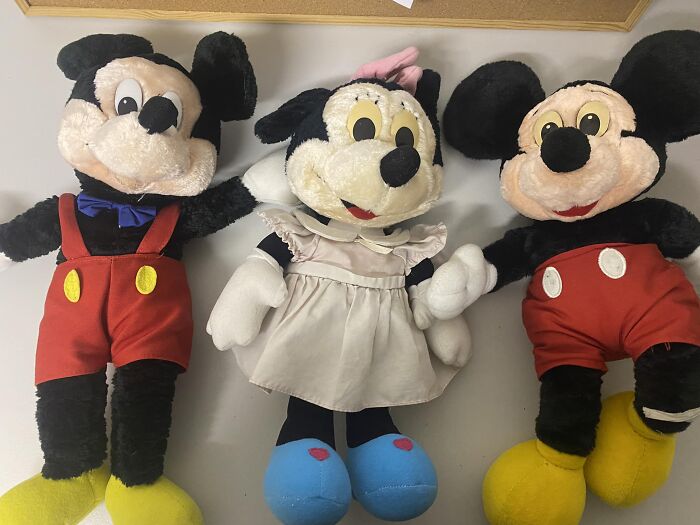 Three vintage stuffed toys resembling classic cartoon characters, representing unexpected things found in walls and hidden places.