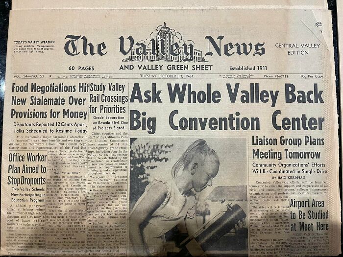 Vintage newspaper clipping found hidden in a wall revealing historical news from 1964 in a home's hidden space.