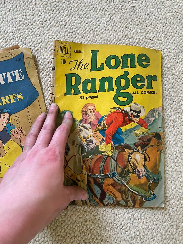 Hand holding a vintage Lone Ranger comic found among unexpected things in walls and hidden places in homes.