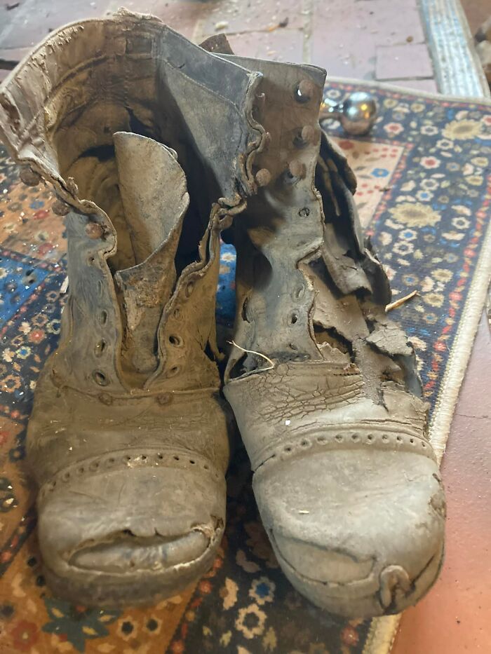 Worn and decayed old leather boots found hidden in walls as unexpected things in people’s homes.