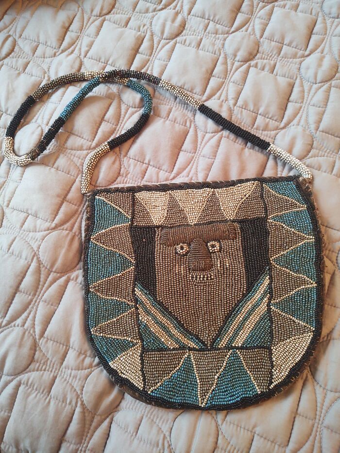 Beaded purse with geometric and animal face design, an unexpected thing found in walls and hidden places in homes.