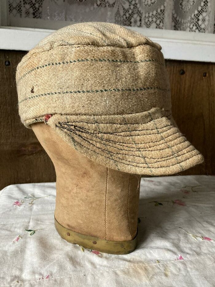 Worn vintage hat displayed on a fabric-covered mannequin head, one of the unexpected things found in hidden places.