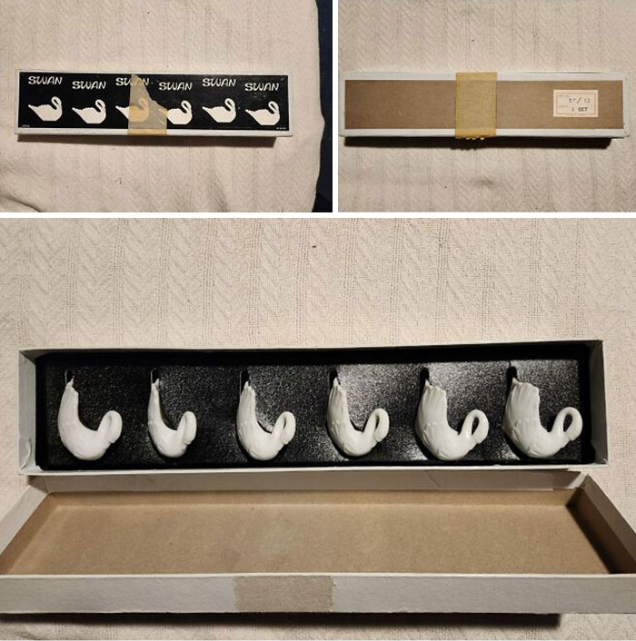 Set of seven vintage swan-shaped hooks displayed in an open box, an unexpected thing found in hidden places in homes.