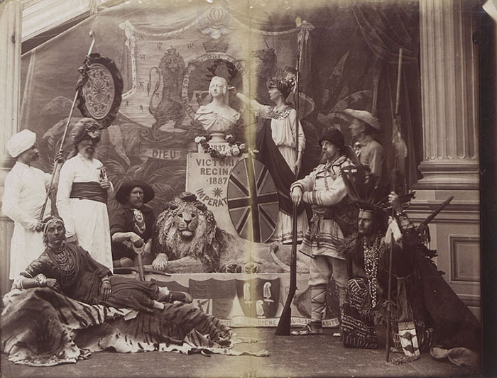 Rare Victorian-era photo shows people in period costumes posing with props and decorations symbolizing British Empire life.