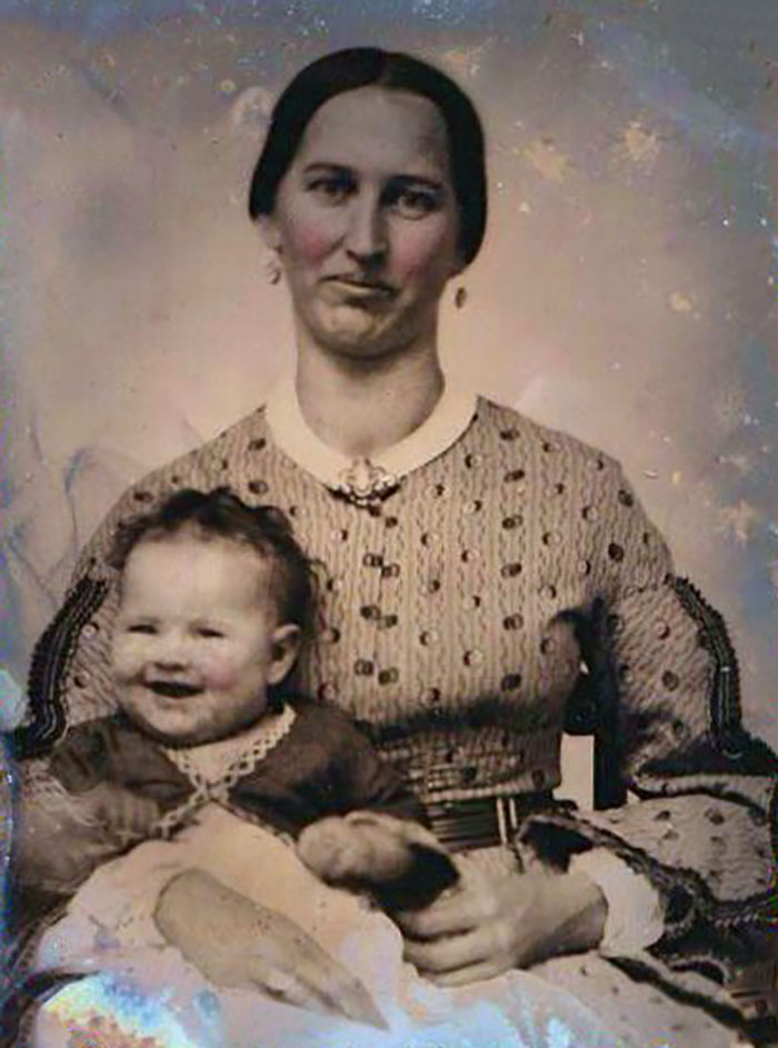 Victorian mother holding baby in a vintage portrait showcasing strange moments from Victorian times.