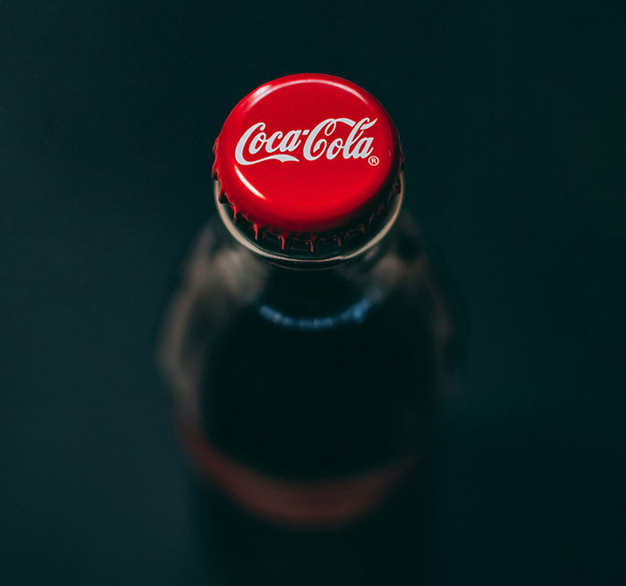 Top view of a glass beverage bottle with a red cap, representing facts to keep the brain active and healthy.