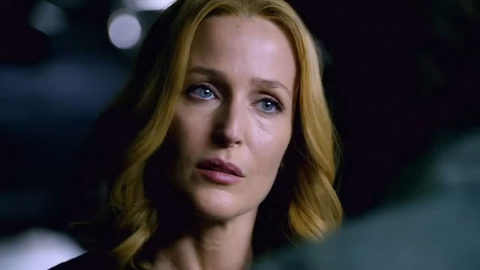 Close-up of a woman with blonde hair and blue eyes in a dim setting, illustrating facts to keep the brain active and healthy.