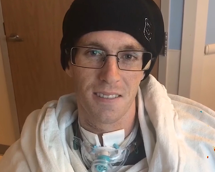 Young Jiu-Jitsu beginner wearing glasses and beanie in hospital after tragic freak accident during sparring session.
