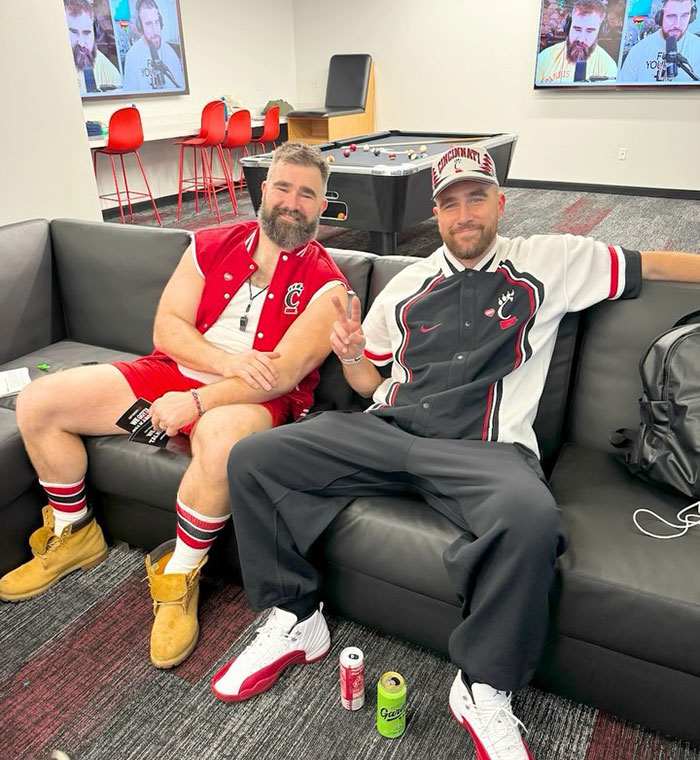 Jason Kelce sitting on a couch with another man, both casually dressed, after a charity event featuring his bulge. Jason Kelce sitting on a couch with another man, both casually dressed, after a charity event featuring his bulge.
