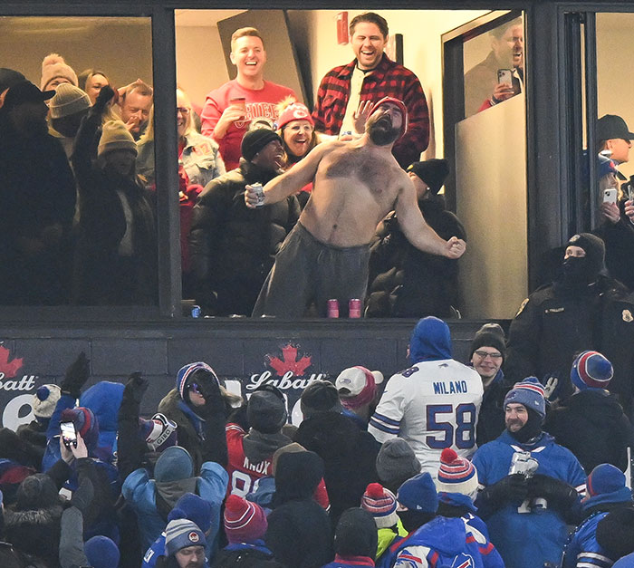 Jason Kelce shirtless and celebrating in front of a crowd during a charity event with fans watching and cheering. Jason Kelce shirtless and celebrating in front of a crowd during a charity event with fans watching and cheering.