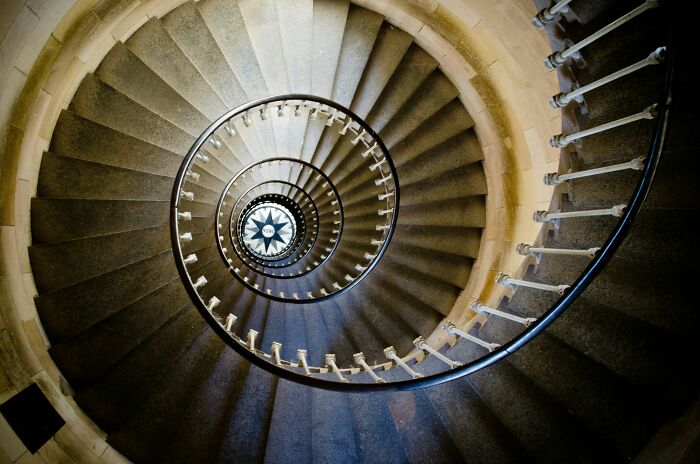 Spiral stone staircase viewed from above, illustrating historical facts with a focus on Da Vinci and wedding planning.