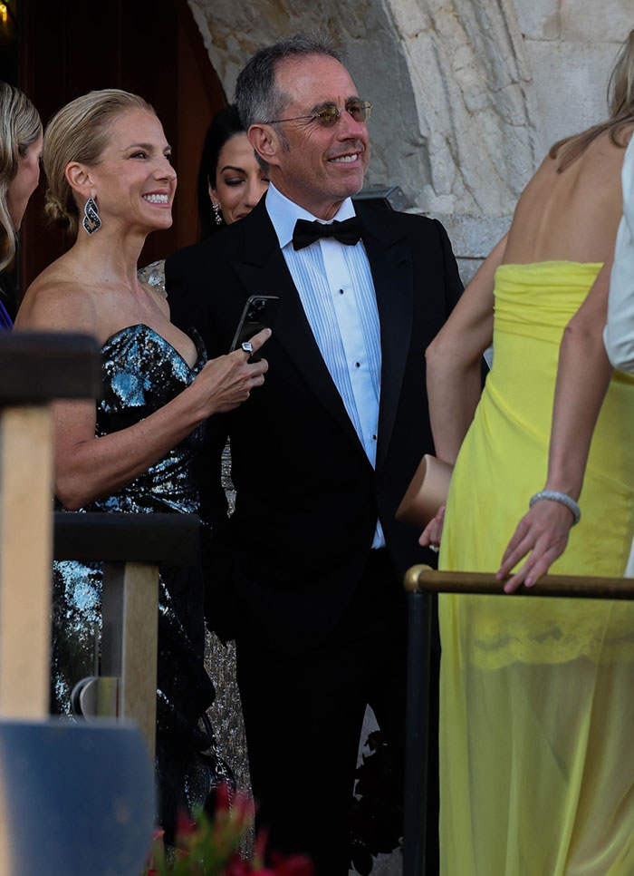 Strung-out celebrity looks at a wedding party, dressed in formal attire, socializing after weekend celebrations.