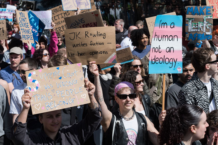 Protesters holding signs at a rally against J.K. Rowling using Harry Potter cash for an anti-trans project. Protesters holding signs at a rally against J.K. Rowling using Harry Potter cash for an anti-trans project.