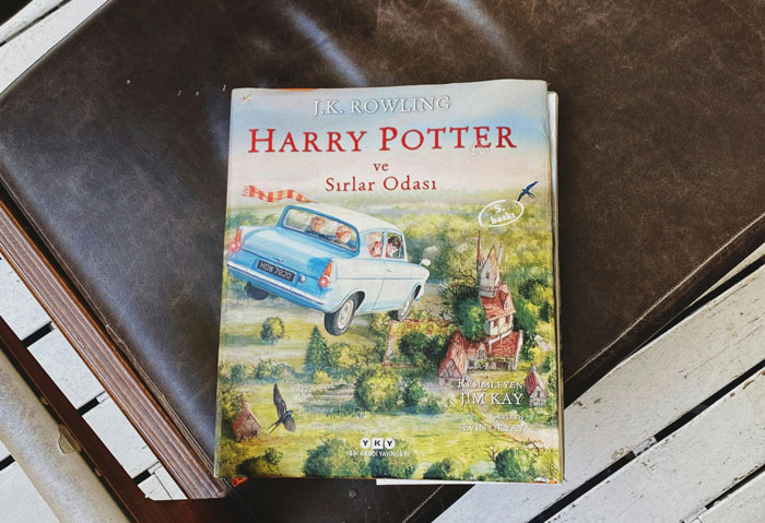 Harry Potter book by J.K. Rowling displayed on a chair, linked to controversy over funding anti-trans projects. Harry Potter book by J.K. Rowling displayed on a chair, linked to controversy over funding anti-trans projects.