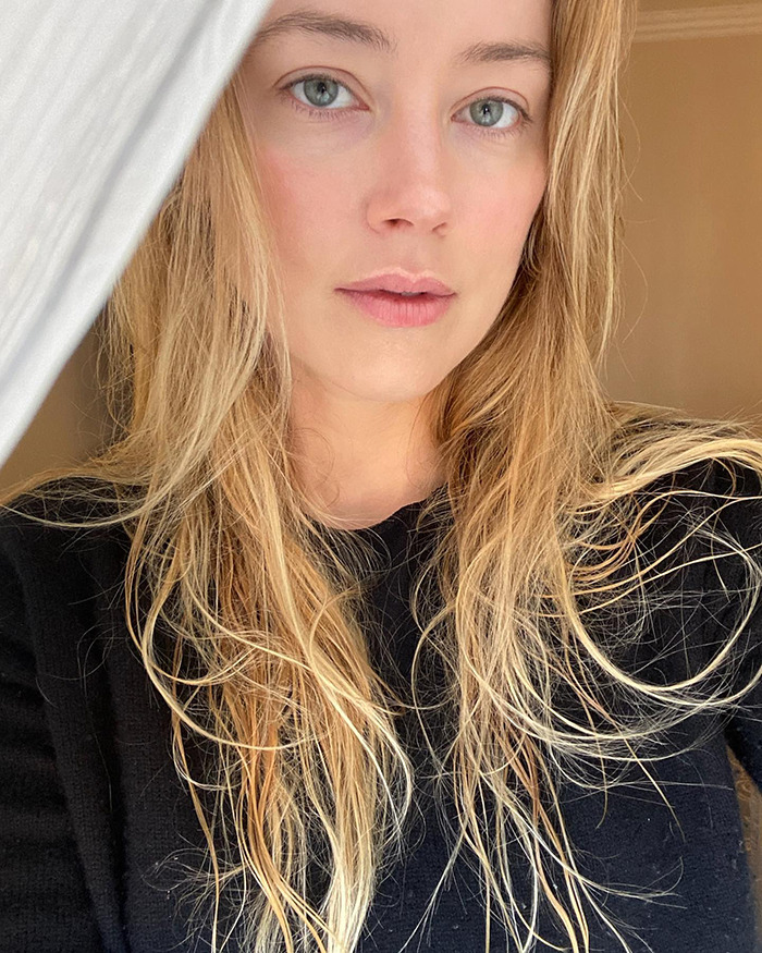 Close-up portrait of a blonde woman with long hair in natural light, related to Johnny Depp and Amber Heard trial discussions.
