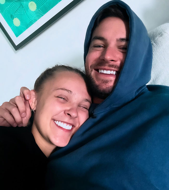 JoJo Siwa smiling and hugging a man in a blue hoodie, responding after Miley Cyrus pride joke sparked backlash. JoJo Siwa smiling and hugging a man in a blue hoodie, responding after Miley Cyrus pride joke sparked backlash.