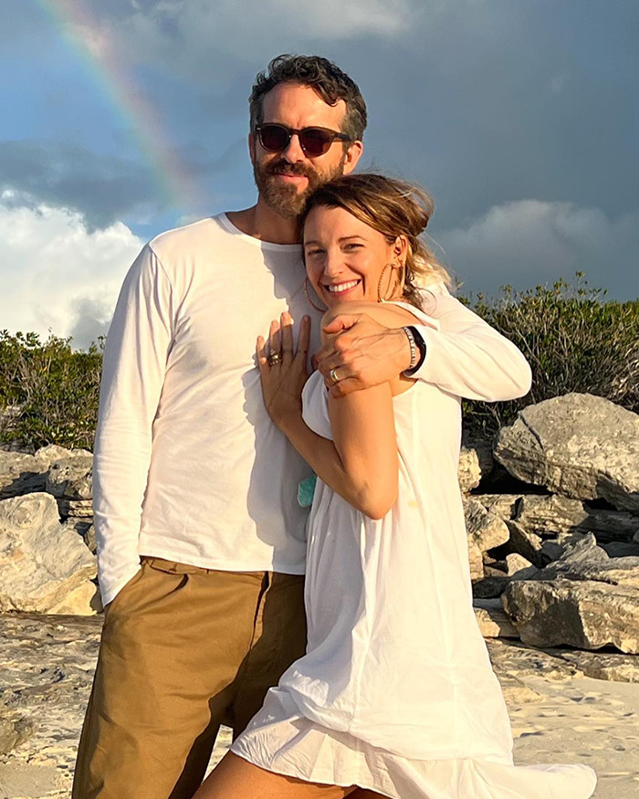 Justin Baldoni and Blake Lively embracing outdoors with rocky landscape and cloudy sky in the background