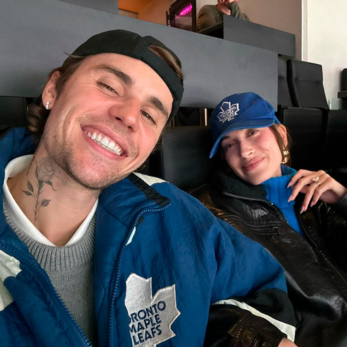 Justin Bieber smiling in a Toronto Maple Leafs jacket alongside a woman, relating to his sad confession after aggressive meltdown. Justin Bieber smiling in a Toronto Maple Leafs jacket alongside a woman, relating to his sad confession after aggressive meltdown.