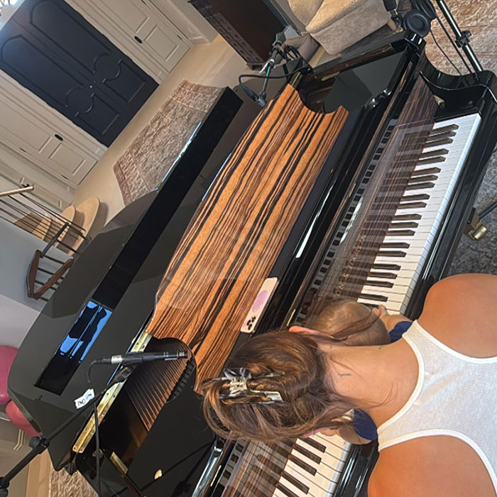 Hailey Bieber playing piano with child, capturing a moment related to Father's Day and revenge on Justin&rsquo;s post.