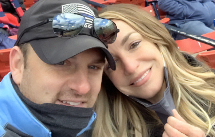 Karen Read and a man smiling close together at an outdoor event, related to trial acquittal and mass fury.