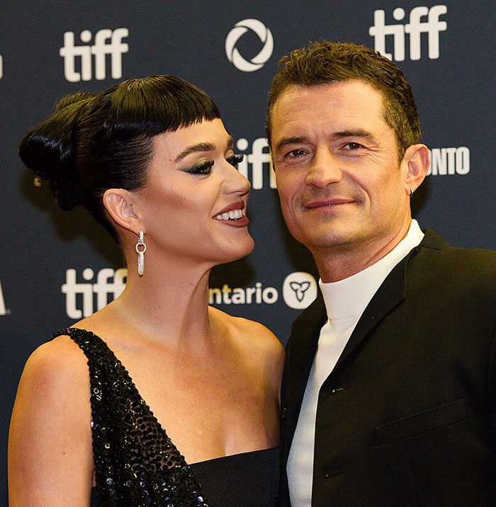 Katy Perry and Orlando Bloom smiling together at TIFF event, dressed formally for the red carpet appearance Katy Perry and Orlando Bloom smiling together at TIFF event, dressed formally for the red carpet appearance