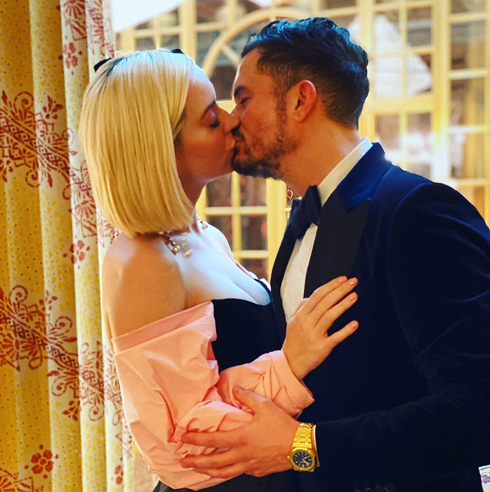 Katy Perry and Orlando Bloom sharing a kiss in elegant attire before their split after six years engaged. Katy Perry and Orlando Bloom sharing a kiss in elegant attire before their split after six years engaged.