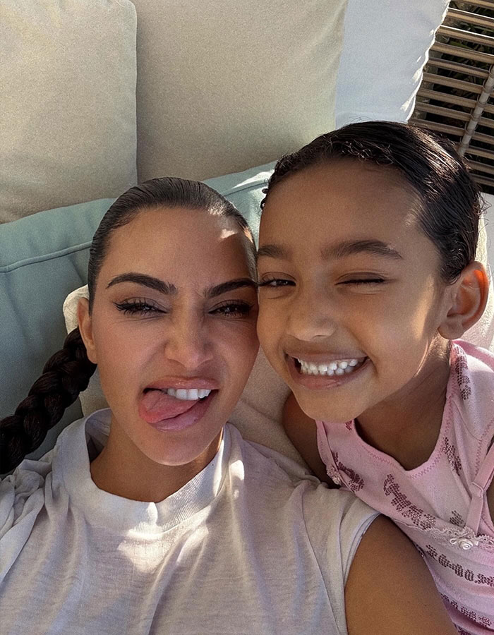Kim Kardashian and her daughter smiling in a throwback selfie sparking discussions about plastic surgeries and natural beauty.