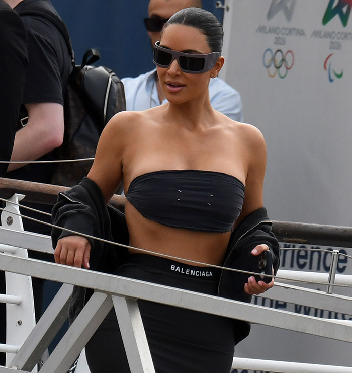 Kim Kardashian showing tiny waist in black outfit at Jeff Bezos' wedding festivities, sparking rib theory discussions.
