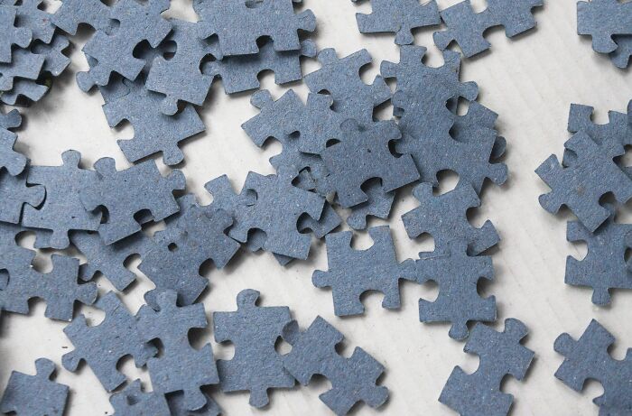 Scattered blue puzzle pieces symbolizing famous paradoxes that make even smart people feel confused and intrigued.