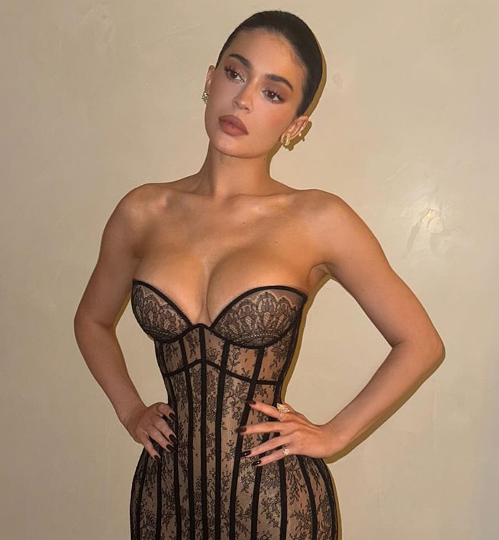 Woman in a black lace corset pose showing toned arms, linked to Ozempic hands side effect concerns by doctors.