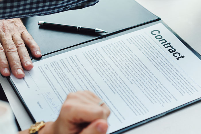 Lawyer and hotelier discussing a contract, highlighting entitlement and negotiation for wedding discount. Lawyer and hotelier discussing a contract, highlighting entitlement and negotiation for wedding discount.