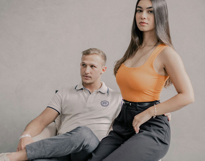 Young man sitting in a chair and woman standing beside him, illustrating lawyers assessing case outcomes.